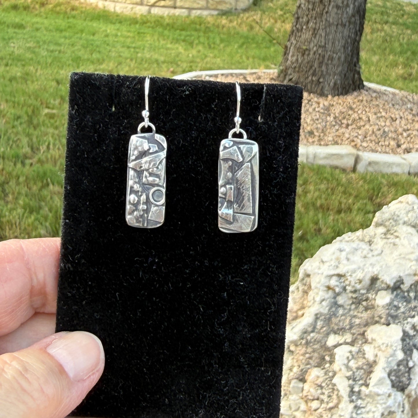 Hand-etched Argentium silver botanical dangle earrings on black velvet display card