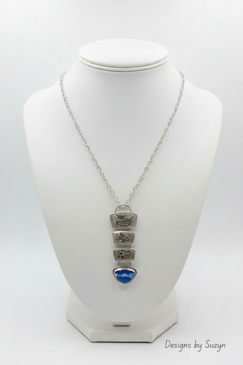Transforma Argentium silver statement necklace with plume agate doublet on white leather bust