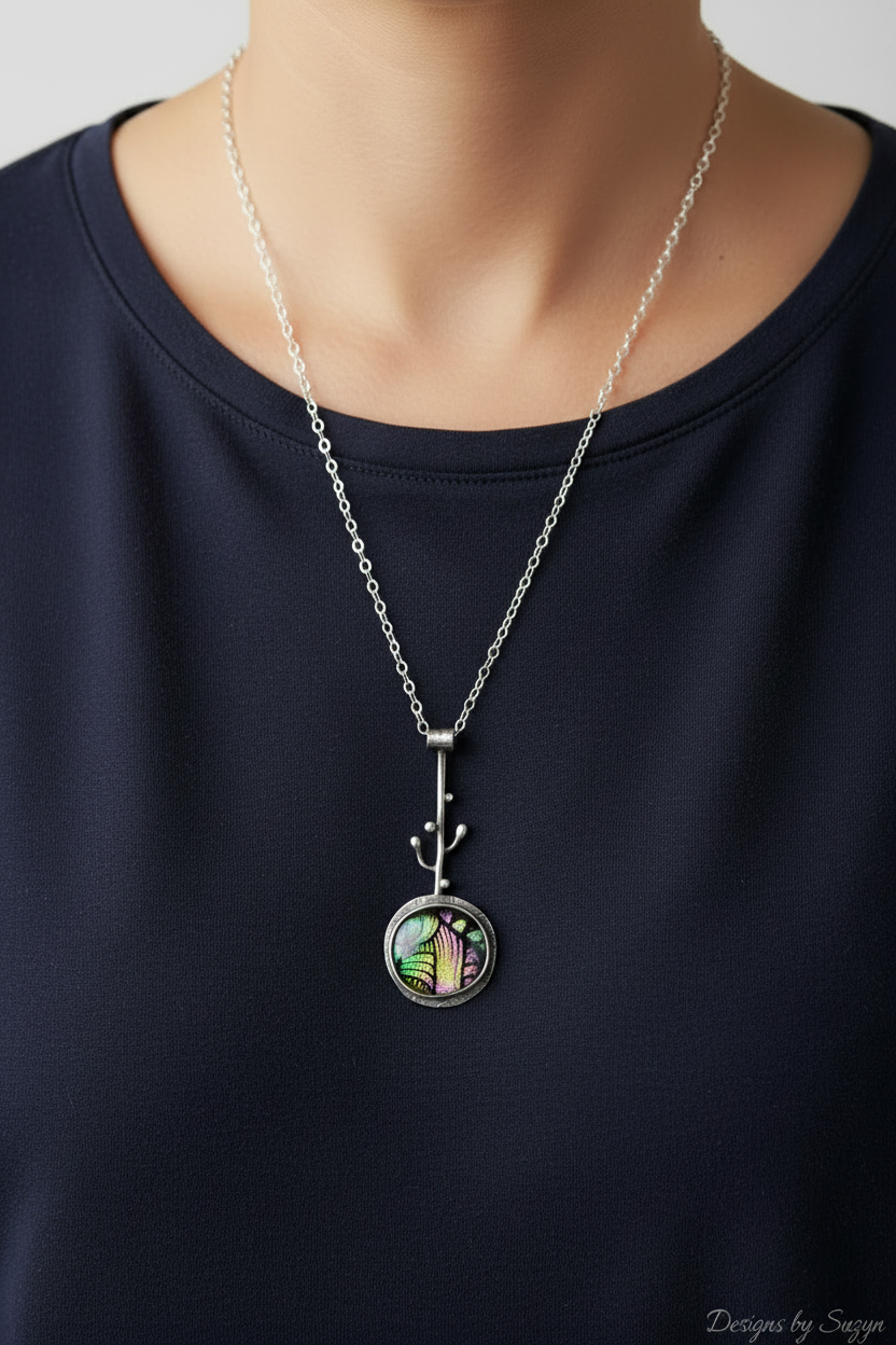 Model wearing dichroic glass pendant necklace with Designs by Suzyn watermark