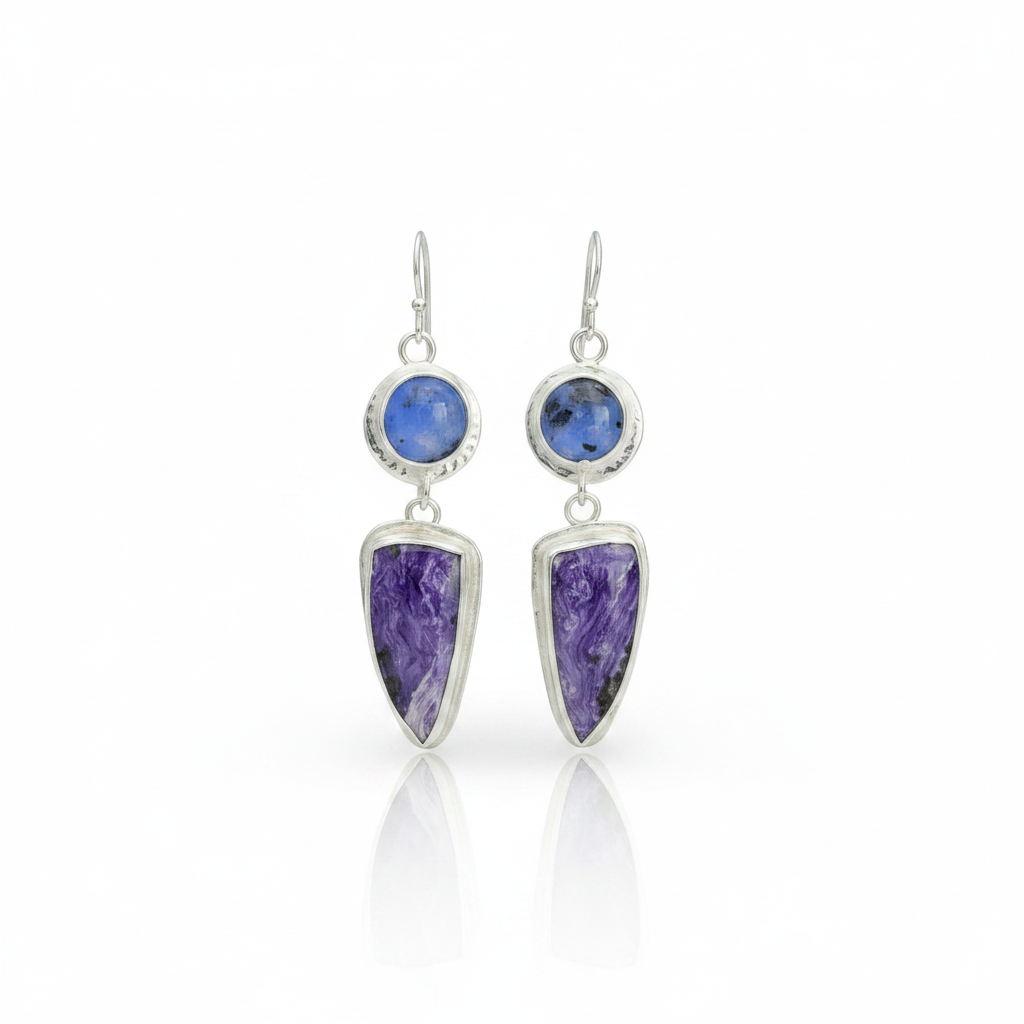 Kiln cast fused glass and charoite sterling silver earrings standing upright on white surface with soft reflection beneath