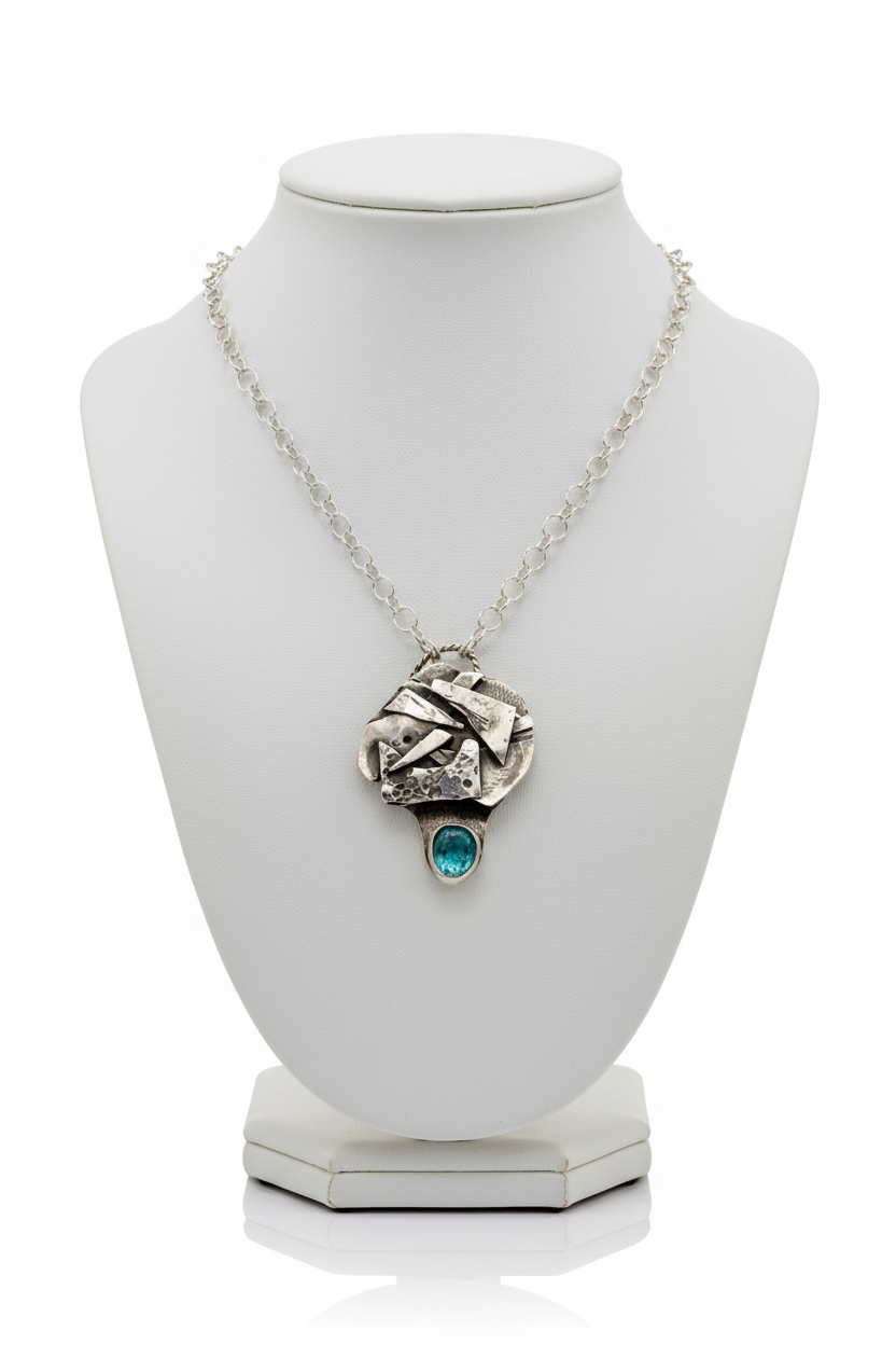 Neon apatite pendant on white necklace bust with natural stone tones