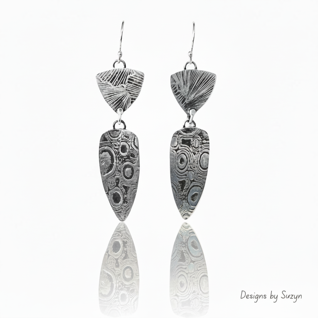 Silver earrings with small bottom reflection